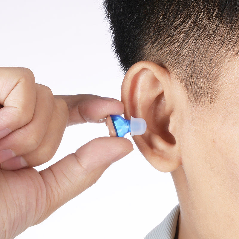 A HearWithUs amplifier worn discreetly in the ear
